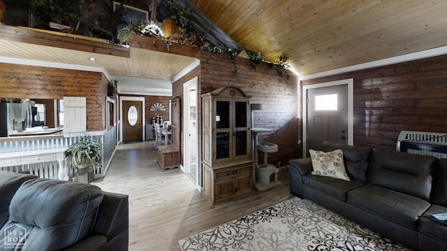 living room with high vaulted ceiling, light wood finished floors, wooden ceiling, and rustic walls