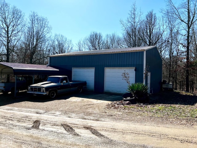garage with dirt driveway and a garage