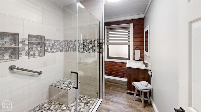 bathroom featuring a shower stall, vanity, and wood finished floors