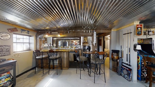 bar with concrete floors and bar area