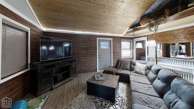 living room featuring wood walls, wood finished floors, vaulted ceiling, and wood ceiling