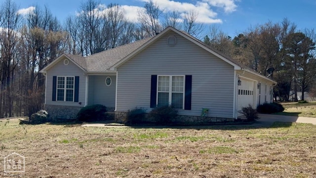 15 County Road 781, Jonesboro, AR 72405 - ranch-style house with a front yard, driveway, and an attached garage