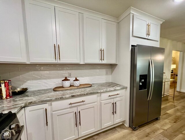 104 N Hunter Ln N, Jonesboro, AR 72405 - kitchen featuring stainless steel appliances, backsplash, white cabinetry, and light wood-type flooring