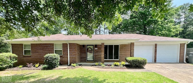 104 N Hunter Ln N, Jonesboro, AR 72405 - ranch-style home featuring a garage, brick siding, driveway, and a front yard