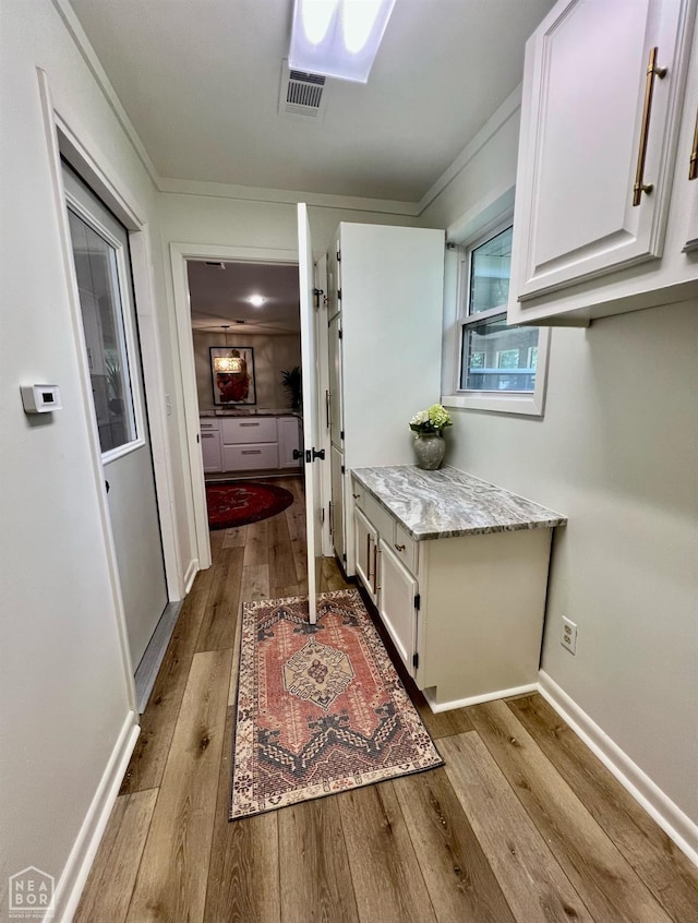 104 N Hunter Ln N, Jonesboro, AR 72405 - bathroom with hardwood / wood-style flooring, ornamental molding, and baseboards