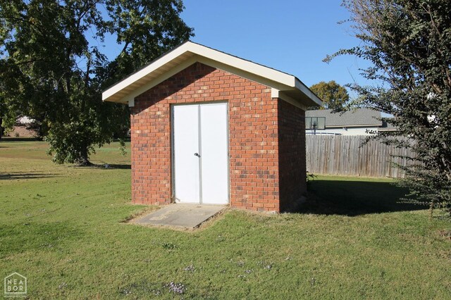 view of shed featuring fence