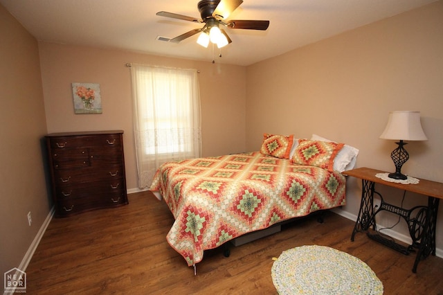 bedroom featuring wood finished floors, baseboards, a ceiling fan, and visible vents
