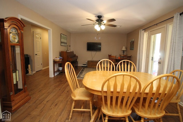dining area featuring baseboards, a ceiling fan, and wood finished floors