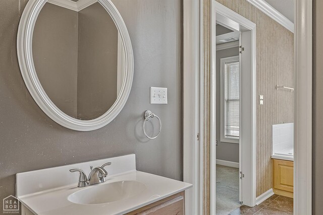 2101 Belleview Cv, Jonesboro, AR 72404 - bathroom featuring crown molding, baseboards, and vanity