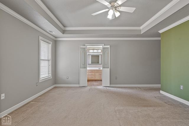 2101 Belleview Cv, Jonesboro, AR 72404 - unfurnished room with crown molding, visible vents, a raised ceiling, and light carpet
