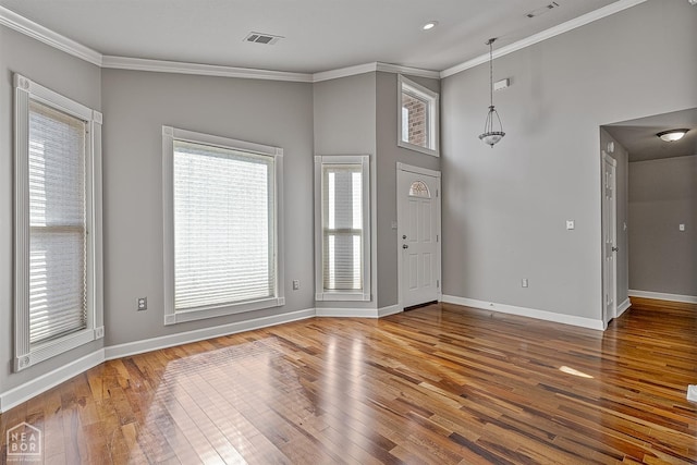 2101 Belleview Cv, Jonesboro, AR 72404 - foyer with wood-type flooring, visible vents, baseboards, and crown molding