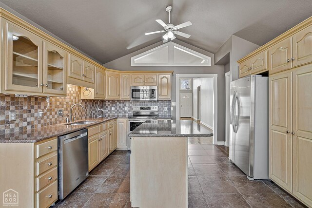 2101 Belleview Cv, Jonesboro, AR 72404 - kitchen featuring dark stone counters, ceiling fan, a kitchen island, appliances with stainless steel finishes, and a sink