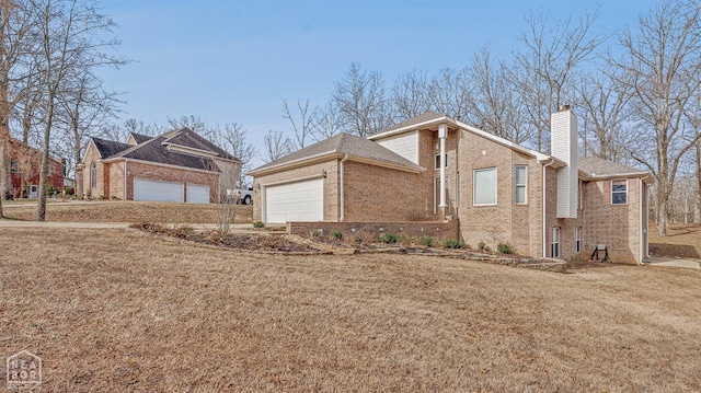 2101 Belleview Cv, Jonesboro, AR 72404 - view of property exterior featuring a yard, a garage, a chimney, brick siding, and roof with shingles