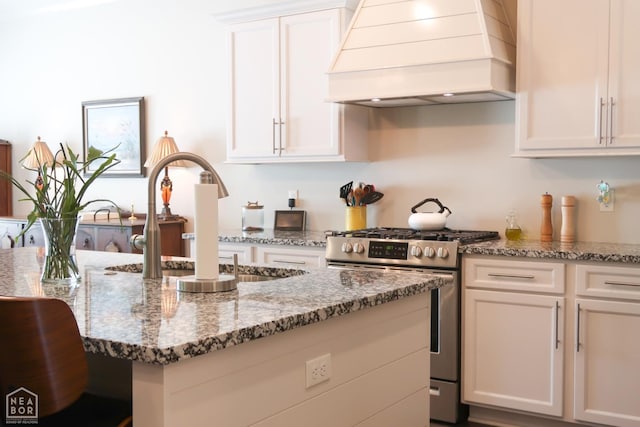 3997 Hwy 351, Jonesboro, AR 72405 - kitchen with stainless steel gas range oven, custom range hood, a sink, white cabinetry, and stone counters