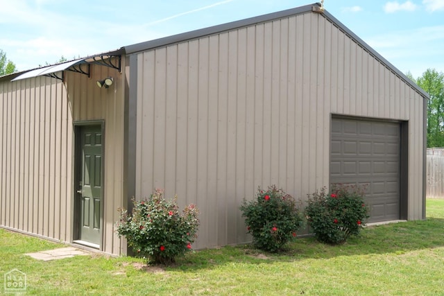 3997 Hwy 351, Jonesboro, AR 72405 - view of property exterior with a garage, an outdoor structure, a lawn, and board and batten siding