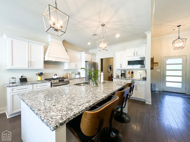 3997 Hwy 351, Jonesboro, AR 72405 - kitchen featuring appliances with stainless steel finishes, premium range hood, a chandelier, a sink, and white cabinets