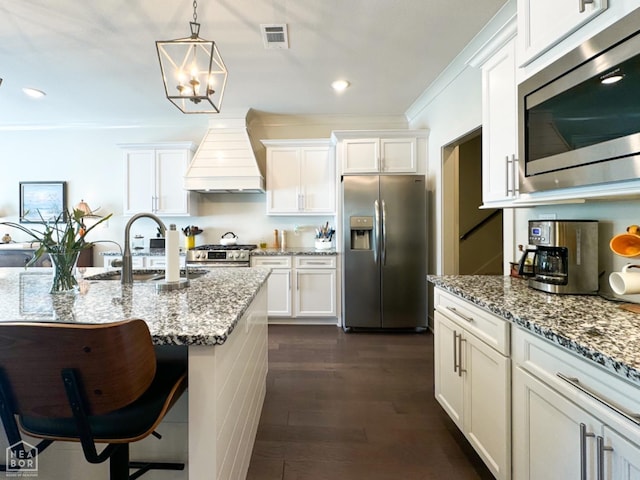 3997 Hwy 351, Jonesboro, AR 72405 - kitchen featuring appliances with stainless steel finishes, a sink, custom range hood, white cabinetry, and light stone countertops