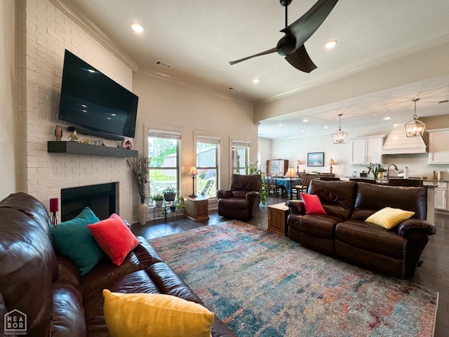 3997 Hwy 351, Jonesboro, AR 72405 - living room featuring wood finished floors, a ceiling fan, recessed lighting, a fireplace, and crown molding