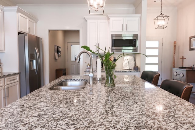 3997 Hwy 351, Jonesboro, AR 72405 - kitchen featuring stainless steel appliances, a sink, a chandelier, white cabinetry, and light stone countertops
