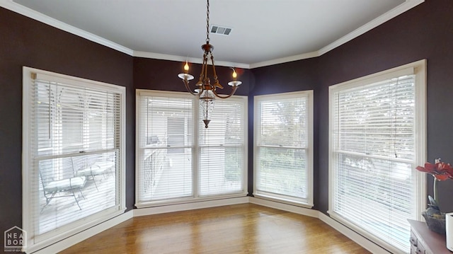3102 Sara Creek Dr, Jonesboro, AR 72401 - unfurnished dining area featuring a chandelier, ornamental molding, and wood finished floors