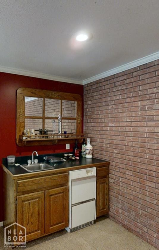 3102 Sara Creek Dr, Jonesboro, AR 72401 - kitchen featuring brick wall, dishwasher, dark countertops, ornamental molding, and brown cabinetry