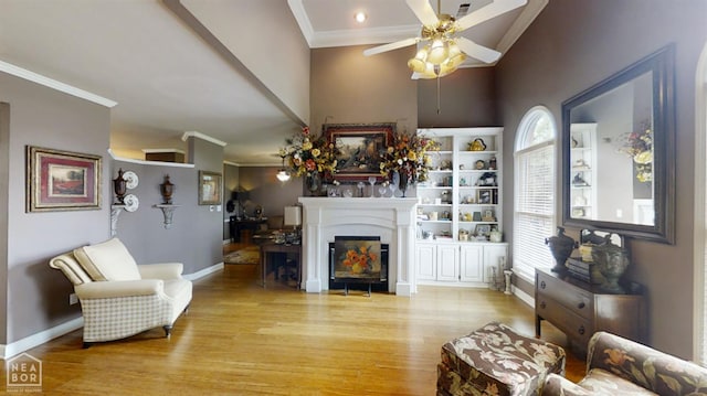 3102 Sara Creek Dr, Jonesboro, AR 72401 - living area featuring crown molding, wood finished floors, a ceiling fan, healthy amount of natural light, and a fireplace