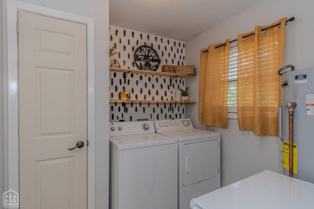 clothes washing area with laundry area, independent washer and dryer, and water heater