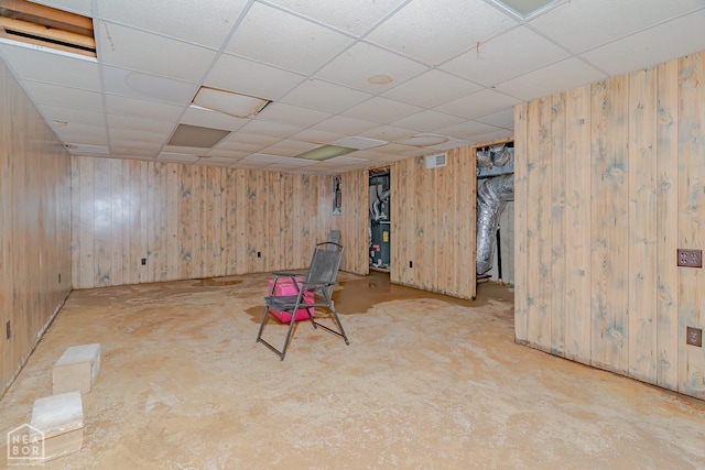 812 Glendale St, Jonesboro, AR 72401 - unfurnished room featuring wood walls, a drop ceiling, and concrete floors