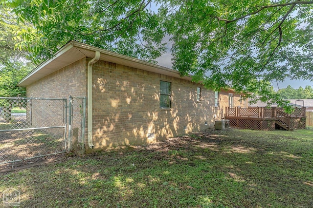 812 Glendale St, Jonesboro, AR 72401 - view of side of property featuring a wooden deck, brick siding, a gate, and central AC unit