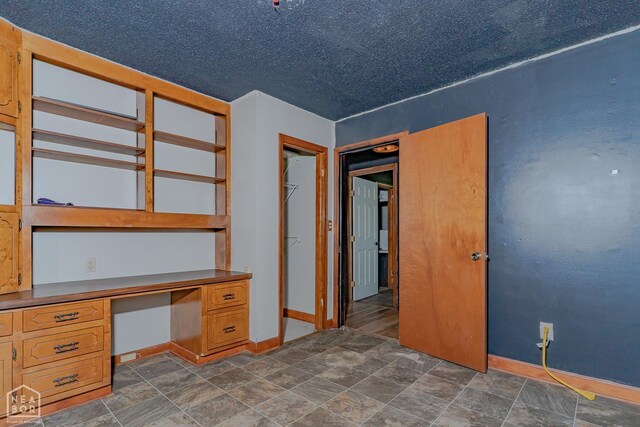 812 Glendale St, Jonesboro, AR 72401 - unfurnished office with built in study area, baseboards, and stone finish floors