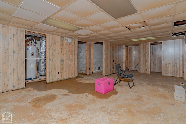 812 Glendale St, Jonesboro, AR 72401 - finished basement with electric water heater, a paneled ceiling, and wooden walls