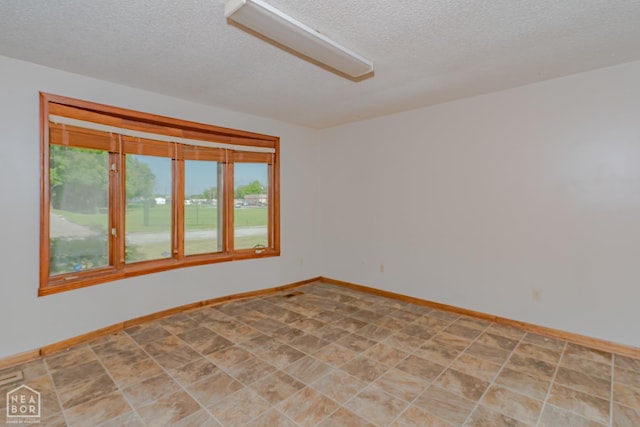 812 Glendale St, Jonesboro, AR 72401 - spare room with a textured ceiling and baseboards