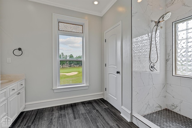 4217 Lochmoor Cir, Jonesboro, AR 72405 - bathroom featuring a tile shower, crown molding, vanity, wood finished floors, and baseboards
