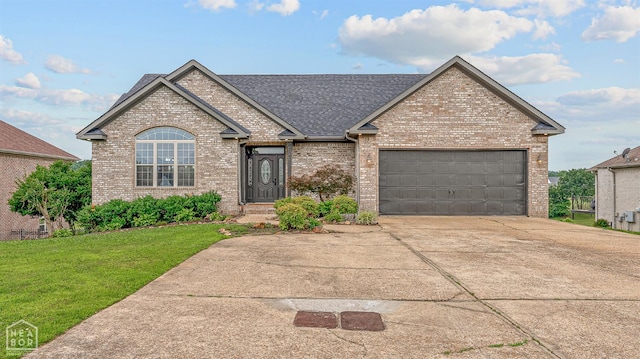 4217 Lochmoor Cir, Jonesboro, AR 72405 - view of front of property with brick siding, a front lawn, an attached garage, concrete driveway, and a shingled roof