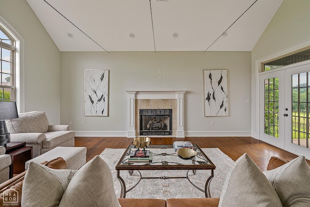 4217 Lochmoor Cir, Jonesboro, AR 72405 - living room with high vaulted ceiling, wood finished floors, a tile fireplace, and baseboards