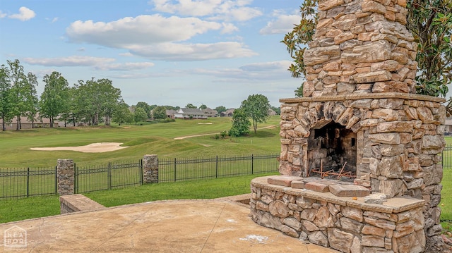 4217 Lochmoor Cir, Jonesboro, AR 72405 - view of patio featuring an outdoor stone fireplace and golf course view