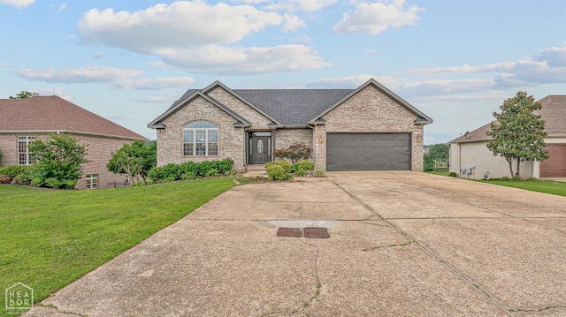 4217 Lochmoor Cir, Jonesboro, AR 72405 - view of front of home featuring brick siding, concrete driveway, an attached garage, a front yard, and a shingled roof