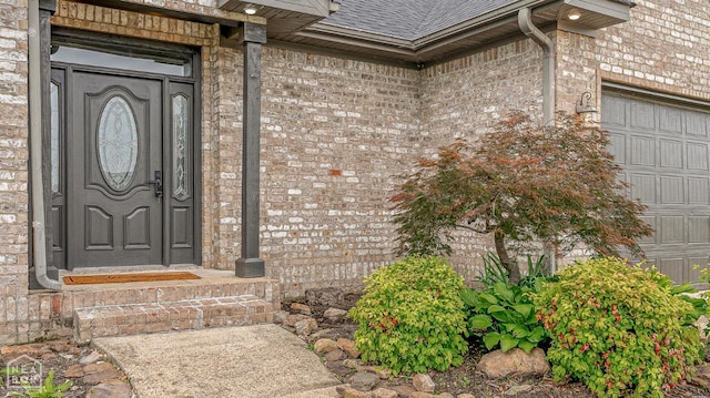 4217 Lochmoor Cir, Jonesboro, AR 72405 - property entrance featuring brick siding, roof with shingles, and a garage
