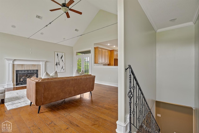 4217 Lochmoor Cir, Jonesboro, AR 72405 - living area with ceiling fan, wood-type flooring, a tiled fireplace, high vaulted ceiling, and ornamental molding
