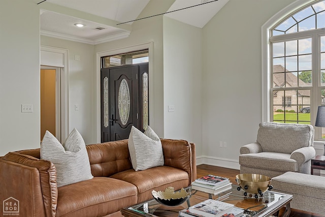 4217 Lochmoor Cir, Jonesboro, AR 72405 - living room with wood finished floors, healthy amount of natural light, ornamental molding, baseboards, and vaulted ceiling