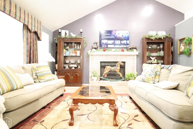 living area with wood finished floors, vaulted ceiling, and a fireplace