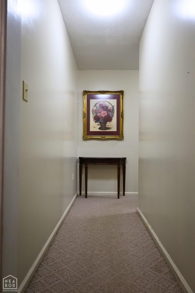 corridor featuring carpet floors and baseboards