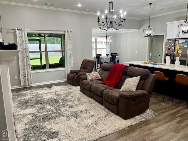 5204 Bridger Park Ct, Jonesboro, AR 72405 - living area featuring wood finished floors, a chandelier, and crown molding