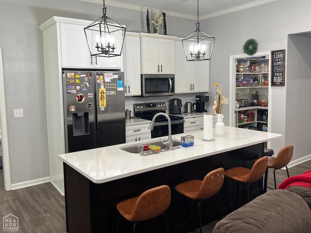 5204 Bridger Park Ct, Jonesboro, AR 72405 - kitchen featuring appliances with stainless steel finishes, a chandelier, dark wood-type flooring, a breakfast bar area, and crown molding