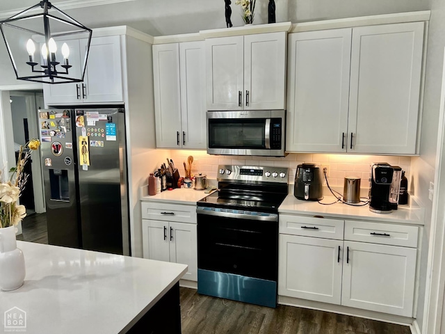 5204 Bridger Park Ct, Jonesboro, AR 72405 - kitchen with stainless steel appliances, light countertops, dark wood finished floors, and backsplash