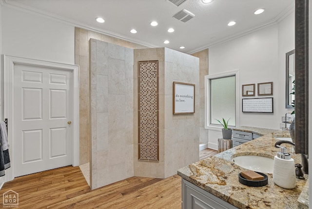 3500 Big Creek Cv, Jonesboro, AR 72404 - full bathroom featuring crown molding, vanity, walk in shower, recessed lighting, and wood finished floors