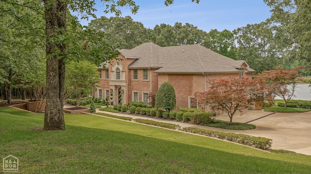 3500 Big Creek Cv, Jonesboro, AR 72404 - georgian-style home with brick siding, a front yard, and roof with shingles
