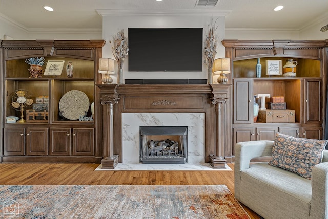 3500 Big Creek Cv, Jonesboro, AR 72404 - living room featuring wood finished floors, crown molding, a premium fireplace, and recessed lighting