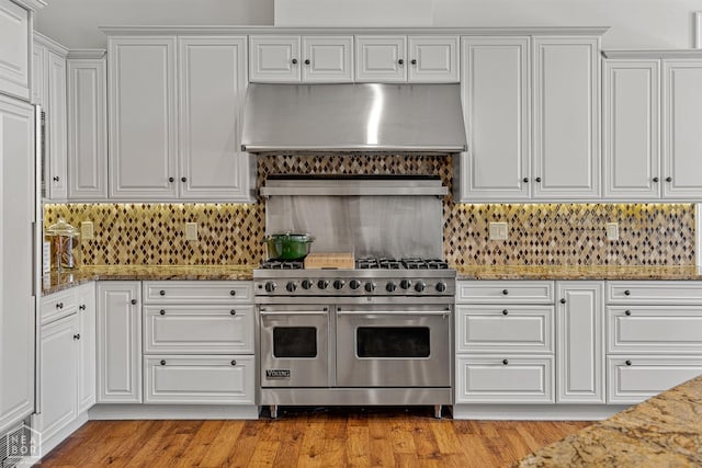 3500 Big Creek Cv, Jonesboro, AR 72404 - kitchen featuring range with two ovens, under cabinet range hood, white cabinetry, and backsplash