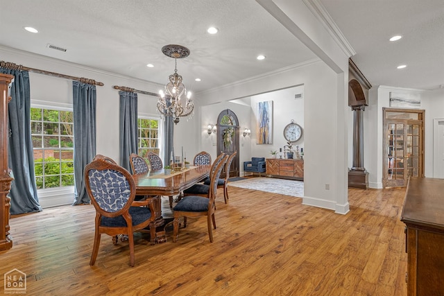 3500 Big Creek Cv, Jonesboro, AR 72404 - dining area featuring crown molding, a chandelier, recessed lighting, light wood-type flooring, and ornate columns